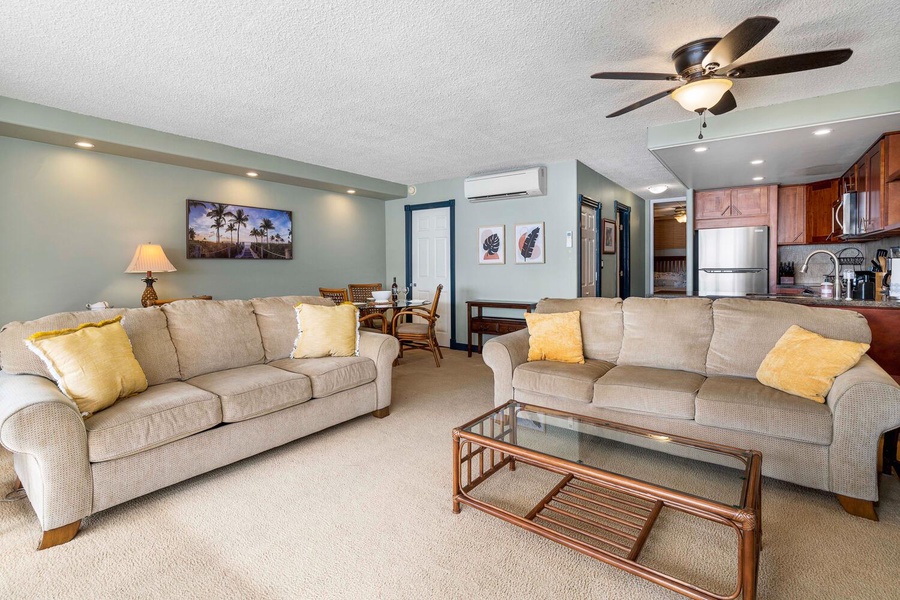 Living area with TV and AC is adjacent to the kitchen and dining areas.