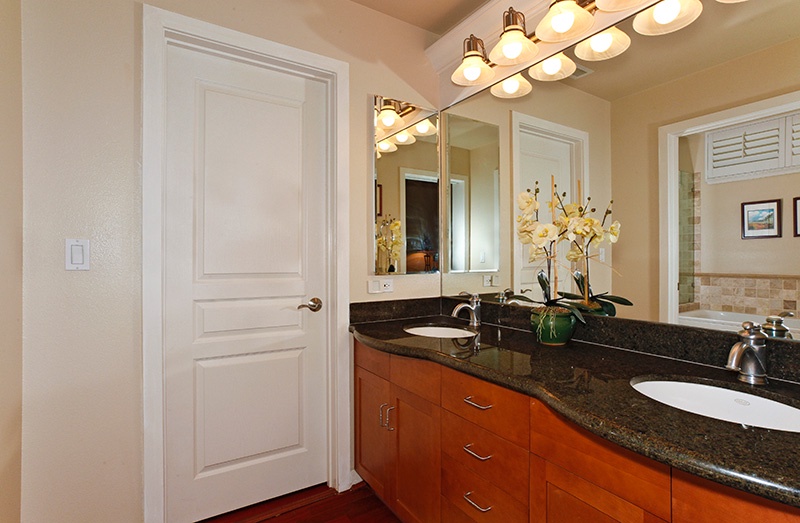 The primary guest bathroom with plentiful space and ample lighting.