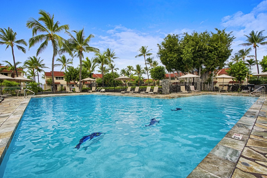 Lounge in style beside the shimmering pool on comfortable chaise lounges — the perfect spot for sunbathing and serene relaxation.