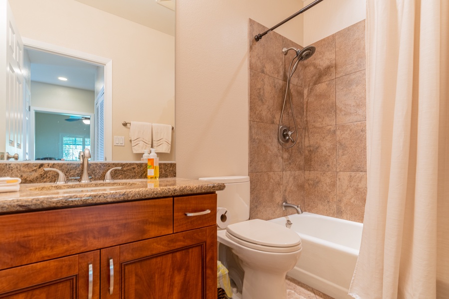 The guest bathroom features a tub and shower combo.