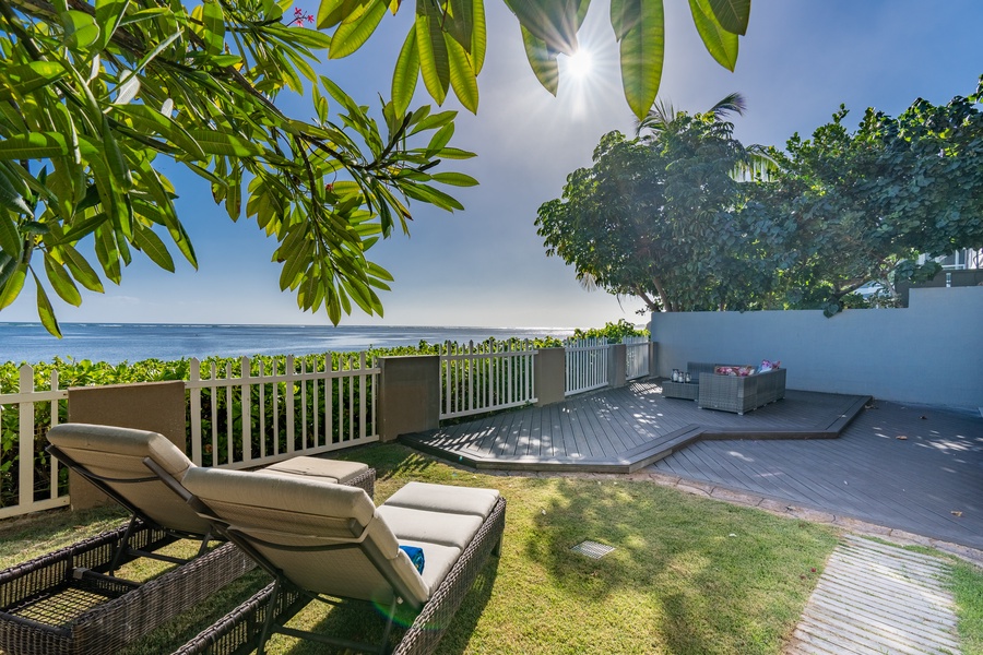 Ocean views and sunshine in private yard with lounge area.