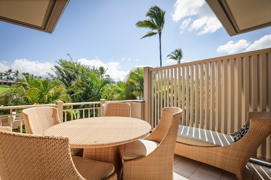 Breakfast table and lounge chair on bonus balcony off the kitchen.