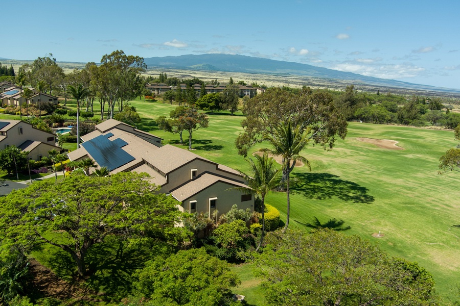 Aerial perspective of Building A reveals its prime corner location and lush surroundings along the golf course fairway.