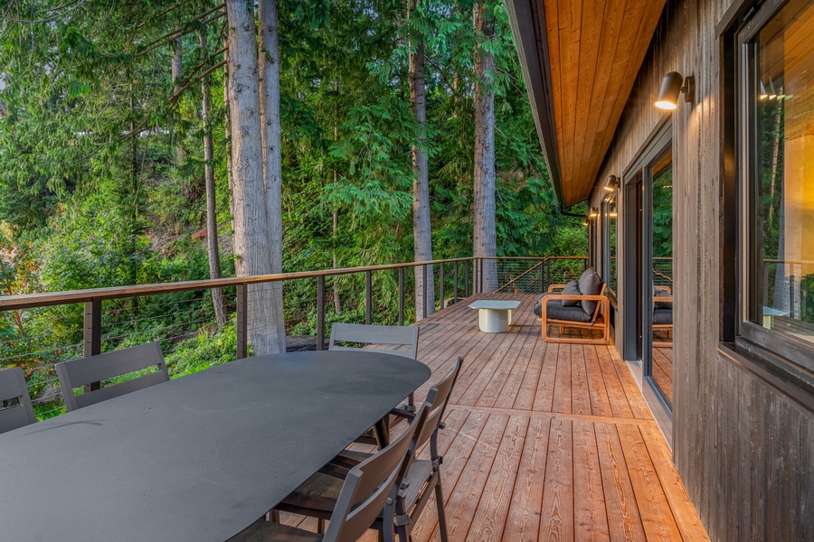 Spacious deck surrounded by nature, perfect for outdoor dining and relaxation.