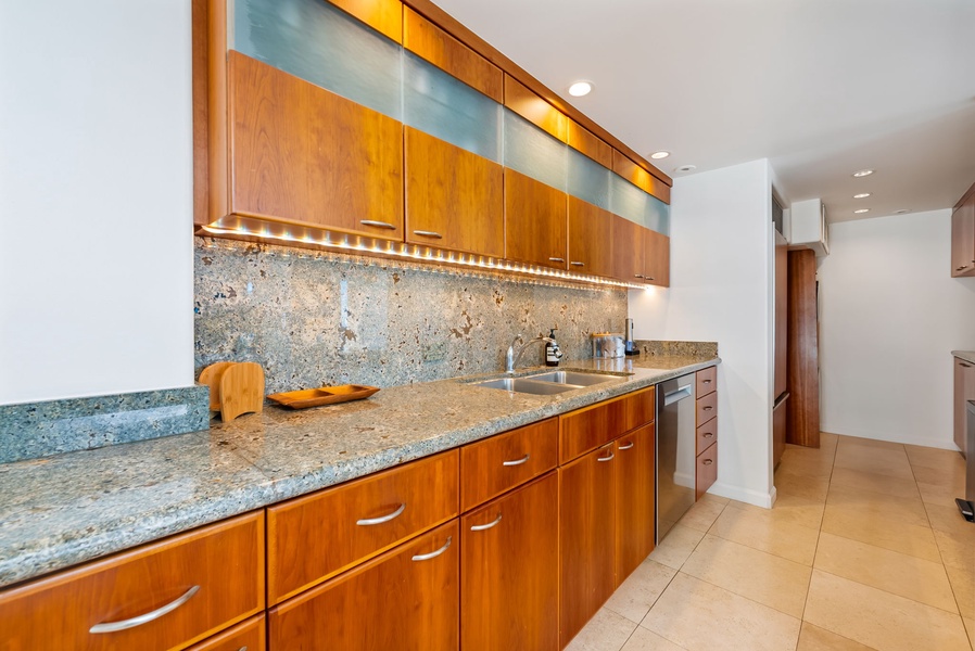 Fully equipped kitchen with granite counters and warm lighting—everything you need for a comfortable and convenient stay.