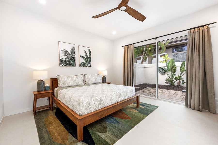 Third guest bedroom with patio access and ceiling fan, a breezy retreat that’s perfect for teens, couples, or extra guests.