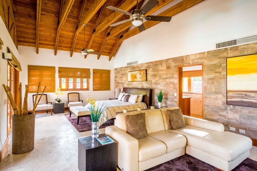 Retreat to the primary suite with a king bed and ample seating area.