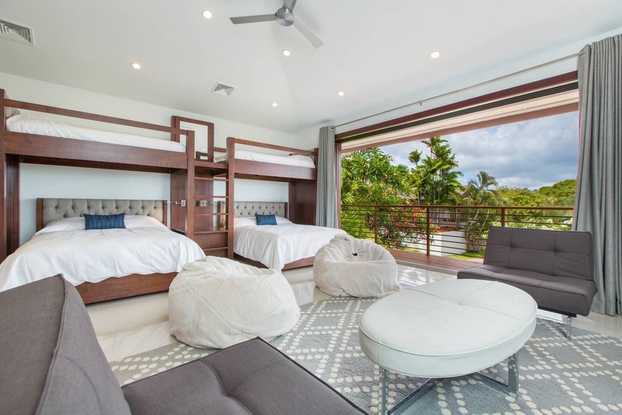 Glass doors open the bedroom onto a private lanai and the garden beyond.