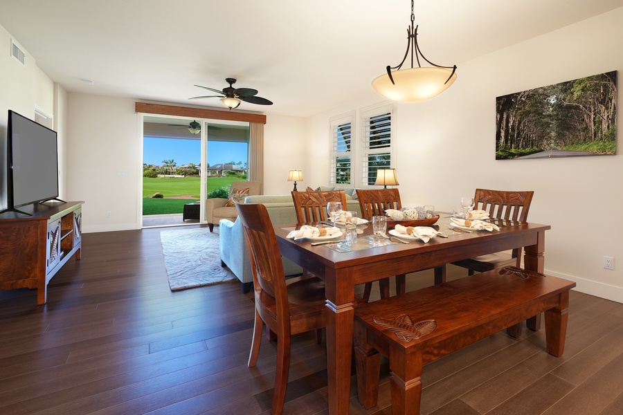 Gather around your elegant dining table with golf course views through sliding doors, perfect for memorable meals.
