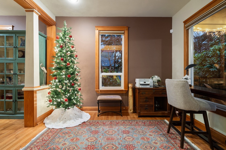 Christmas tree lighting up the dining room, adding warmth and cheer to the home.