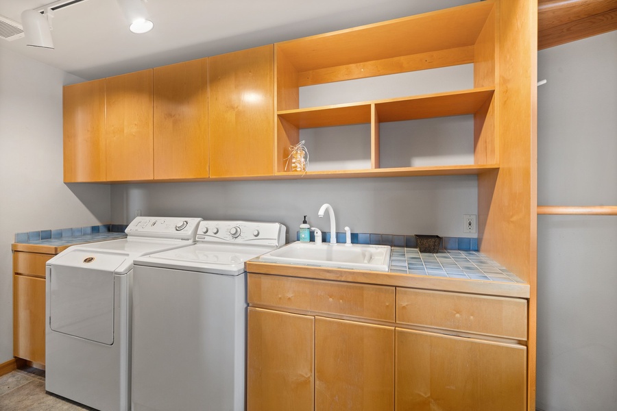 A roomy laundry area with a washer and a dryer