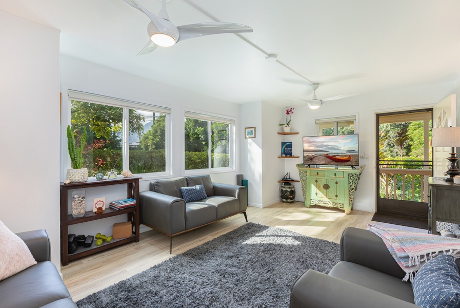 Main living area filled with natural light, complete with Smart TV and comfortable seating for your group.