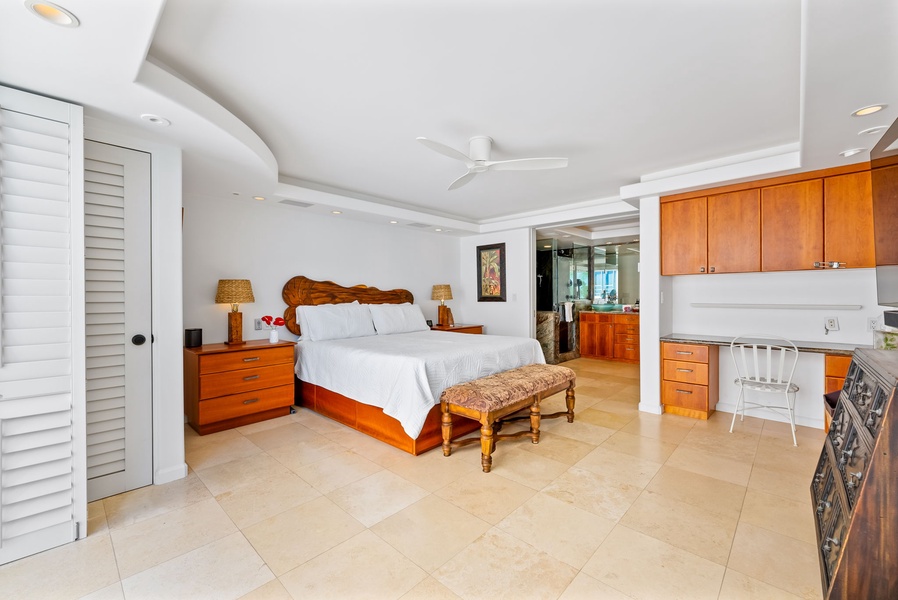 Bright, airy bedroom with elegant decor and ceiling fan for comfort, creating a serene and inviting space to unwind