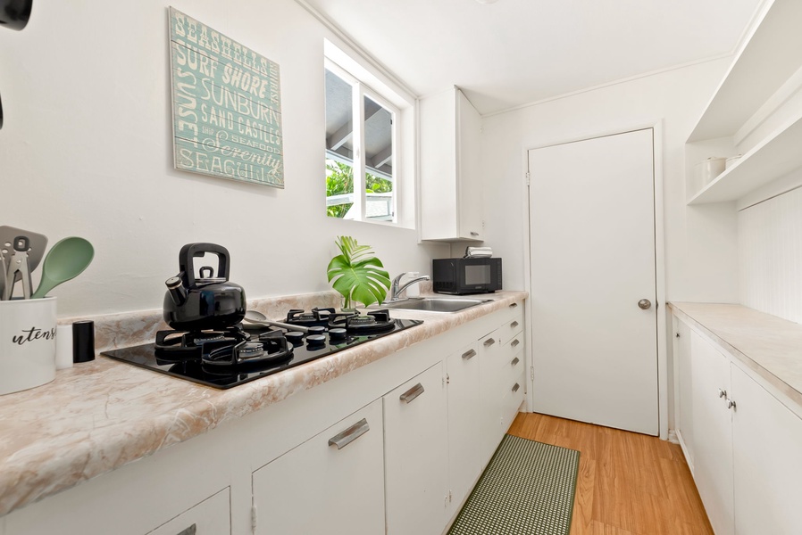 Your bright, fully-equipped kitchen invites easy meal prep with modern appliances, ample counter space, and coastal charm—perfect for cooking at your own pace.