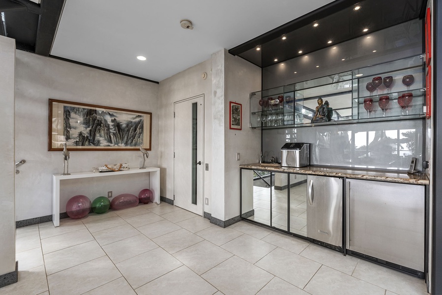 A sleek wet bar with high-end finishes, perfect for entertaining in this luxury retreat.