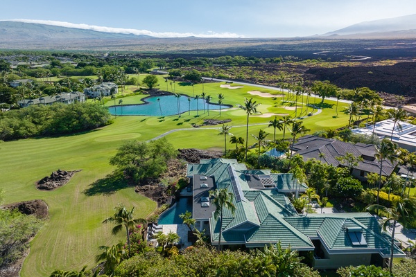 Aerial view of Canoe House at Champion Ridge, a luxurious home overlooking a scenic golf course and lush landscapes