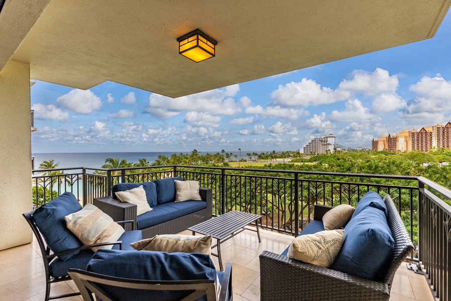 Unwind on your private balcony with plush seating while taking in stunning ocean and city views.