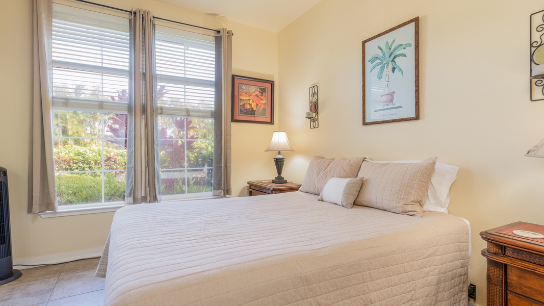 The second guest bedroom with sunshine views and framed art.