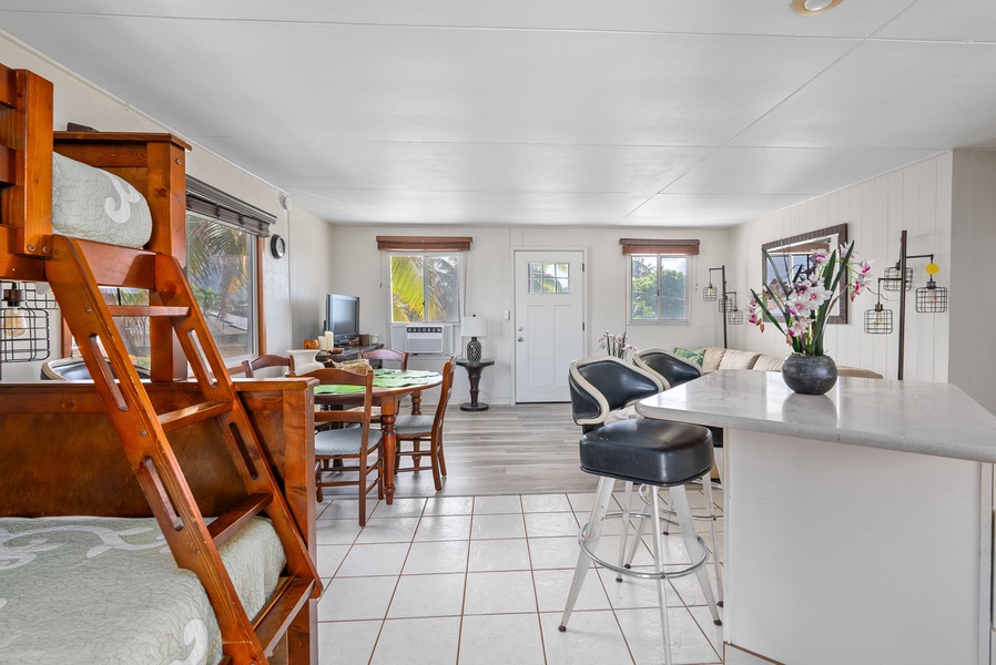 Open-concept layout with bar seating and effortless indoor-outdoor flow.