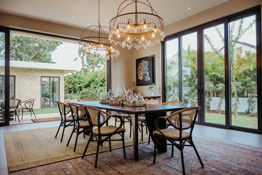 Enjoy delicious meals on this spacious dining area with glass doors offering views of the garden.