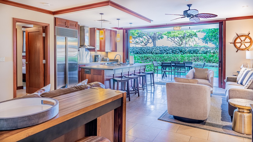 An open floor plan with kitchen, dining and living area.