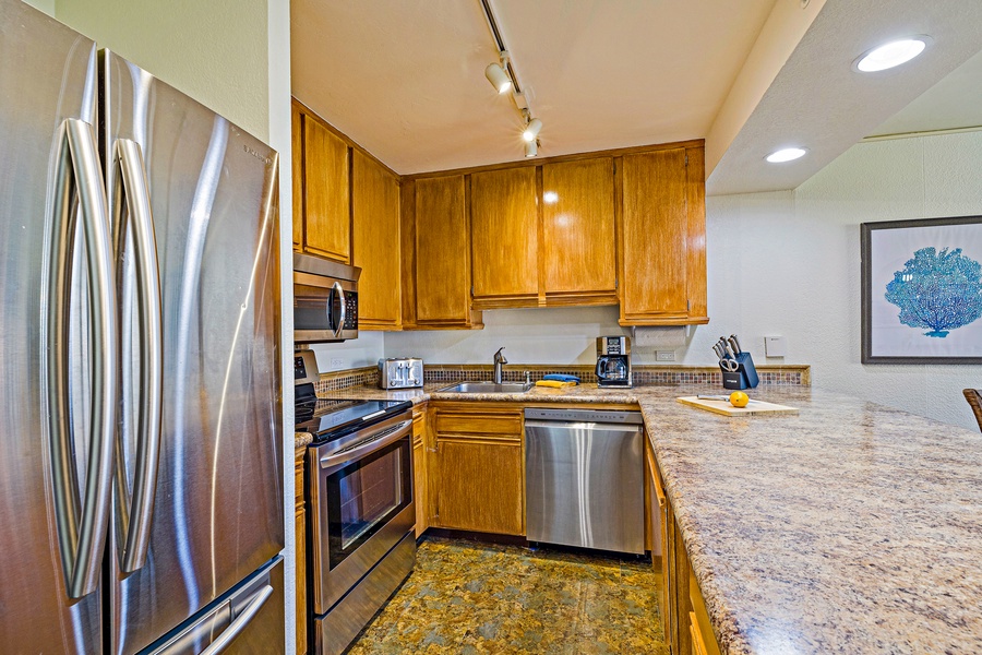 The kitchen at Kaanapali Shores 544 features modern appliances and ample space for family meals.