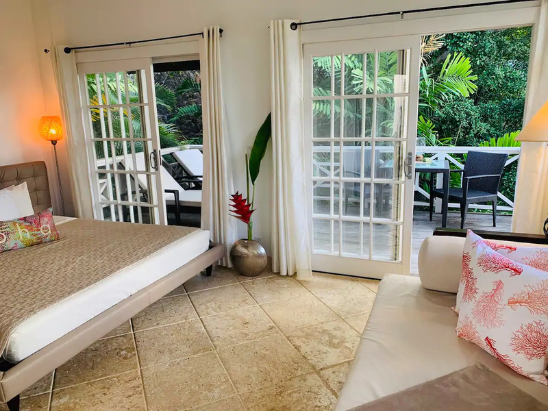 Your tropical sanctuary awaits with French doors opening to your private terrace surrounded by lush greenery.