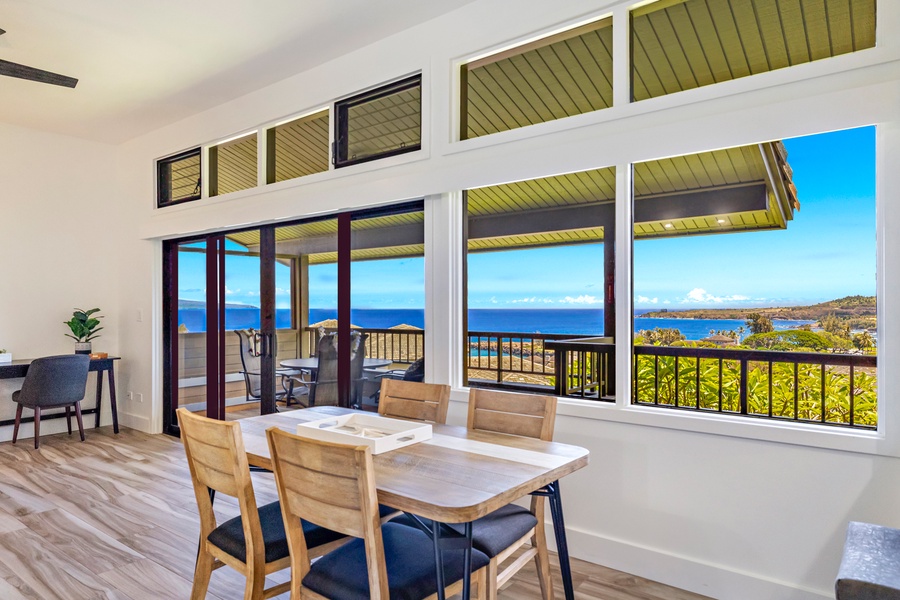 The dining area offers breathtaking ocean views through large windows and sliding doors, creating a perfect setting for enjoying meals