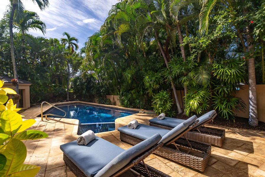 Unwind on plush loungers beside your private pool, surrounded by swaying palms and tropical gardens in this peaceful oasis.