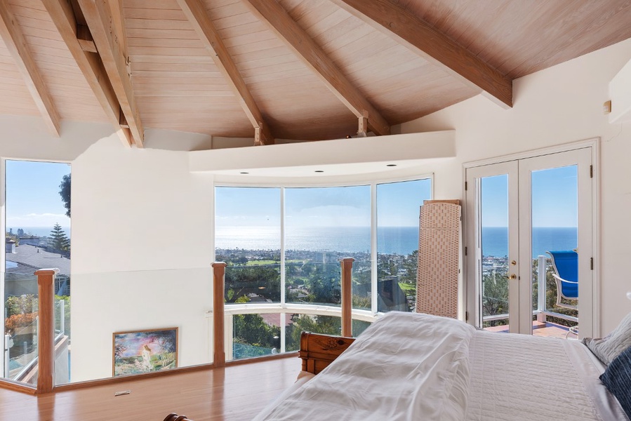 Panoramic views right in your bed with floor to ceiling curved windows. Privacy screens are used in lieu of window coverings.  Glass loft opens to downstairs poolside gym.