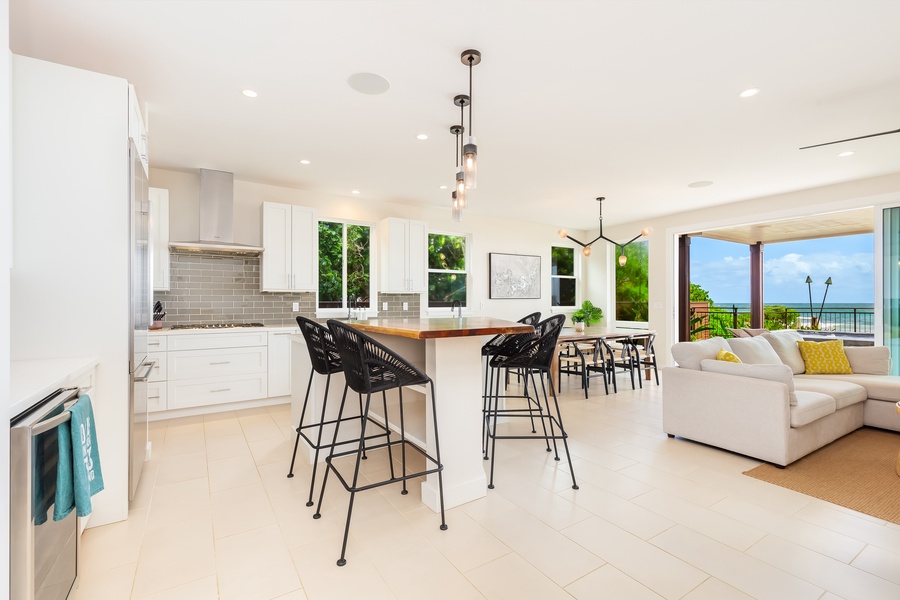 Kitchen corner with a wine cooler, bar seating, and direct access to outdoor dining areas.