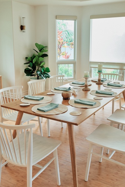 Gather around this beautifully styled dining table where your family meals become memorable moments with natural light streaming through large windows.