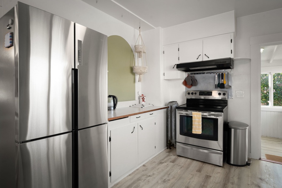 Cook comfortably in the bright kitchen with stainless steel appliances and easy flow.