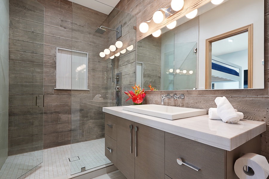 Rejuvenate in this modern bunk room ensuite, complete with sleek finishes, a spacious shower, and vibrant touches of color for a refreshing start or end to your day.