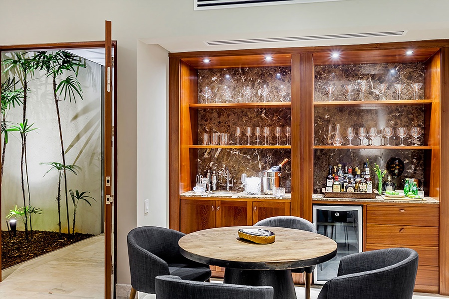 Enjoy a cool drink in the stylish bar corner, perfect for entertaining or unwinding.