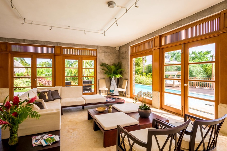 Gather in the bright living area leading to the pool and garden.