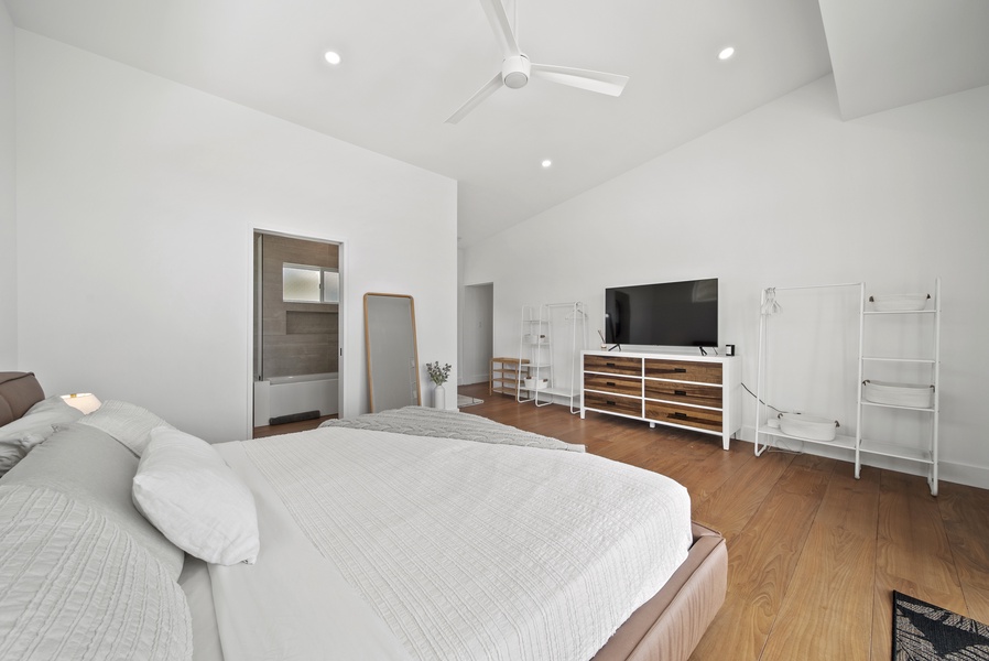 The primary suite offers a plush king-sized bed and smart TV for ultimate comfort.