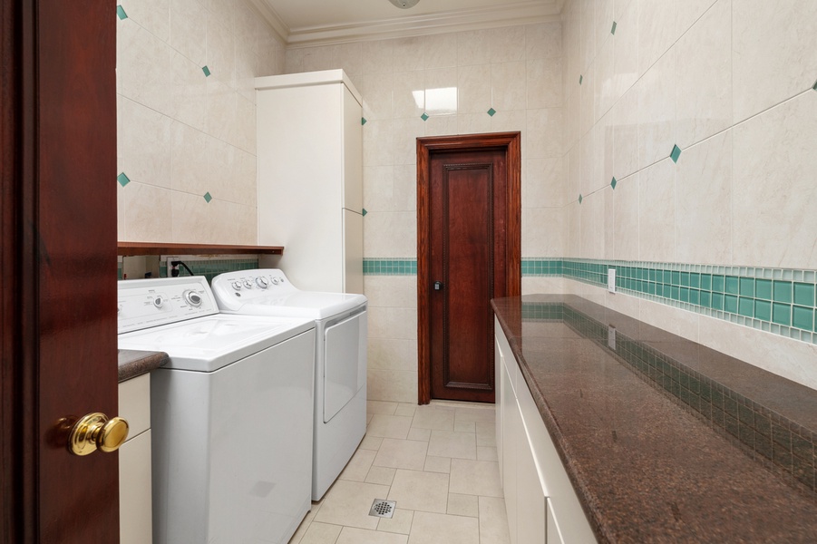 A thoughtfully designed laundry room where smart organization and clean finishes make every task feel effortless.