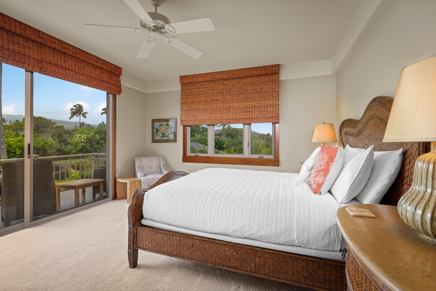 Upper level guest room with queen bed and private balcony with views of Mt. Hualalai.