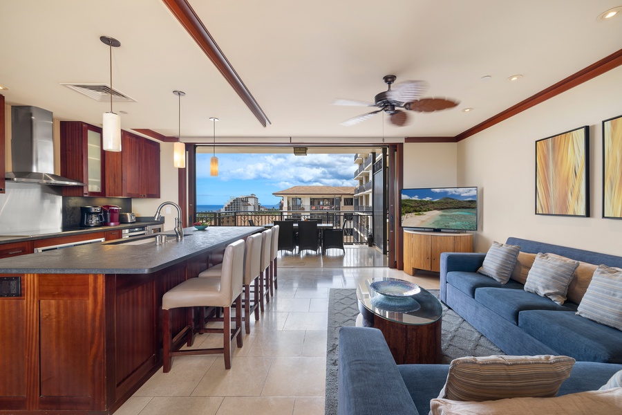 Relax in your open-concept living space where rich wood finishes meet ocean breezes through floor-to-ceiling doors opening to paradise.