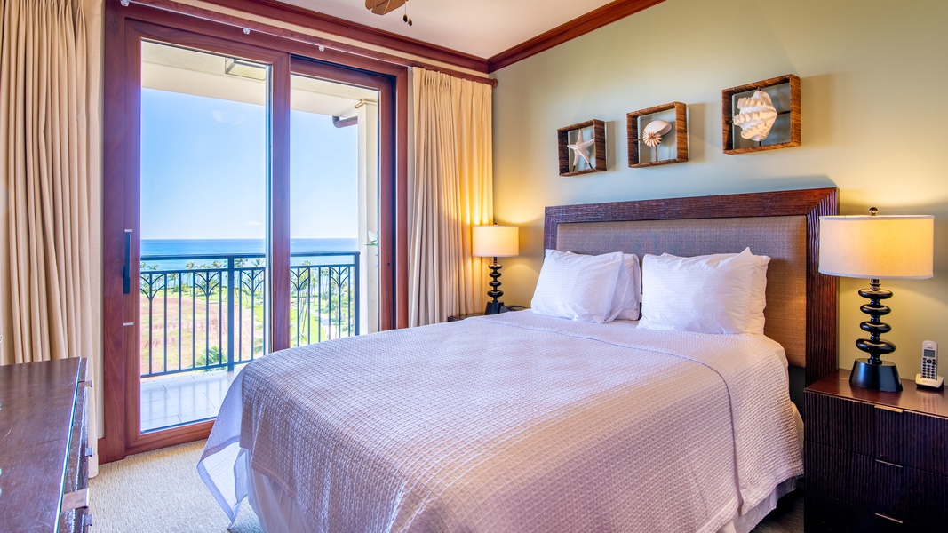 The second guest bedroom has a queen bed with lanai access, perfect for a restful sleep.