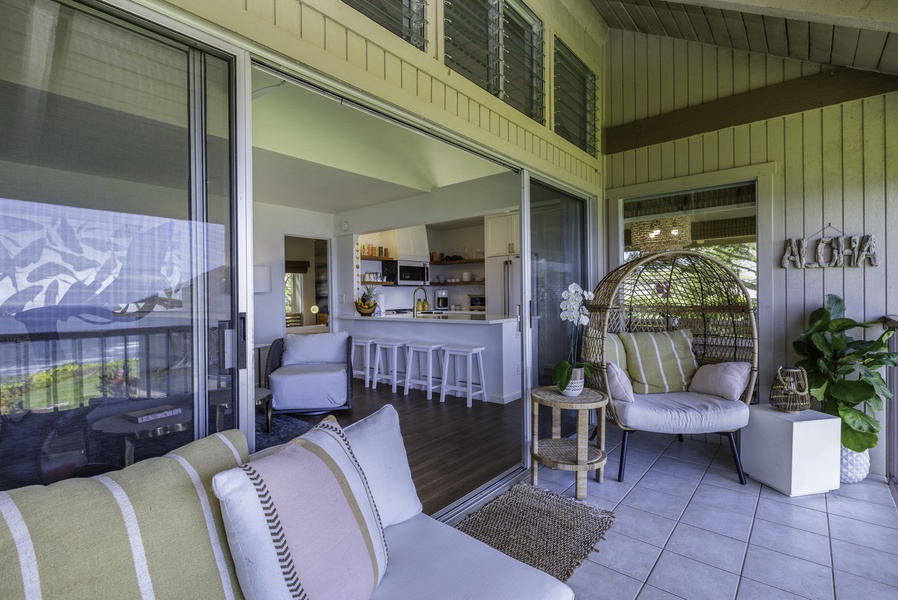 Expansive glass sliders connect the living room to the sizable lanai, where ocean breezes, sea and garden views, and outdoor dining options await you