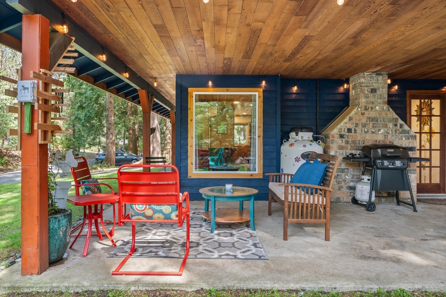 Colorful chairs and wood ceilings create a picture-perfect spot to relax beneath the trees.