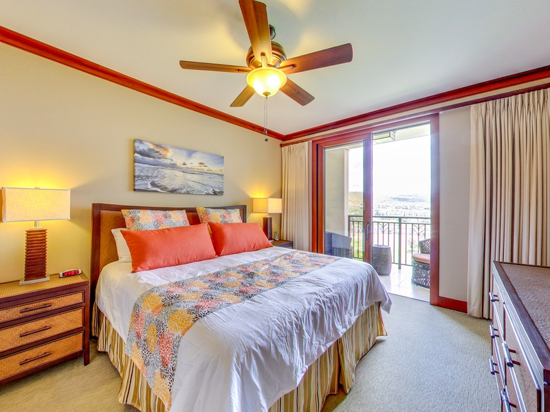 The primary bedroom with lanai, ceiling fan, and captivating views.