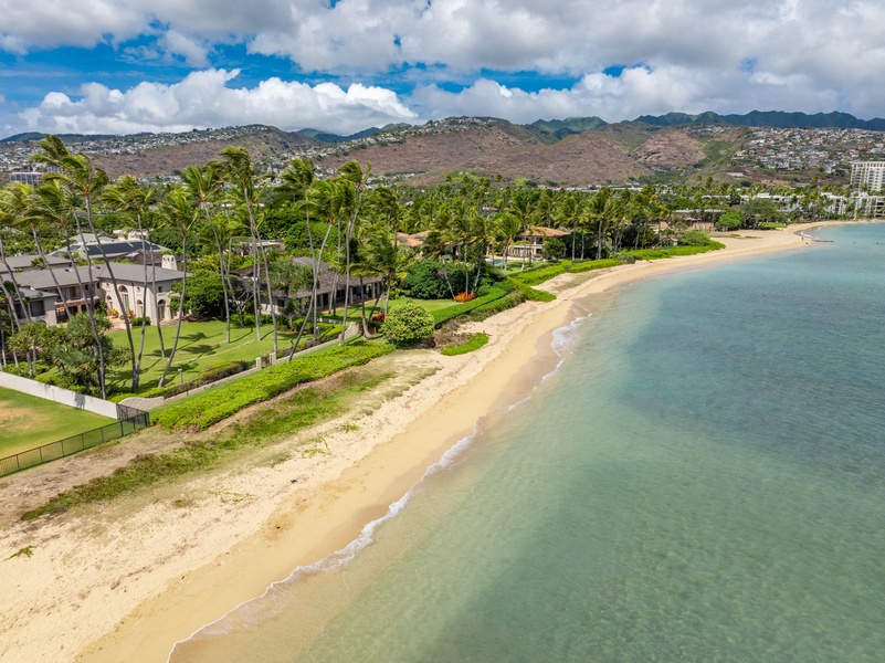 Stunning beachfront view showcasing the sandy shore and crystal-clear ocean waters, ideal for a tropical retreat.