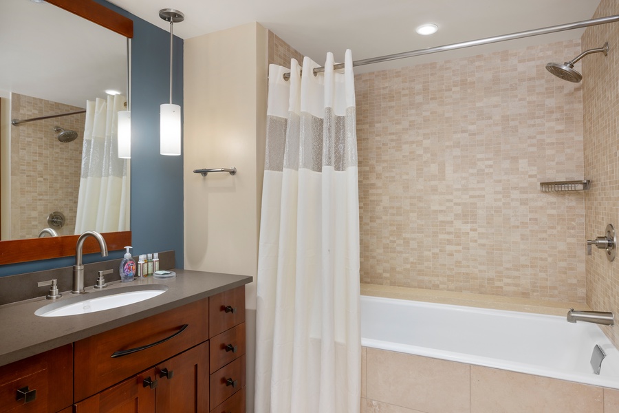Unwind in your elegant bathroom with a deep soaking tub, refreshing shower, and modern vanity—your perfect retreat after exploring.