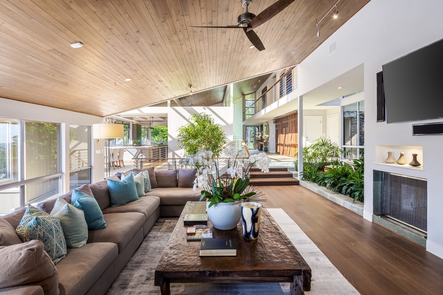 Spacious lounge with oversized sectional and spectacular city-to-ocean views—perfect for evening relaxation.