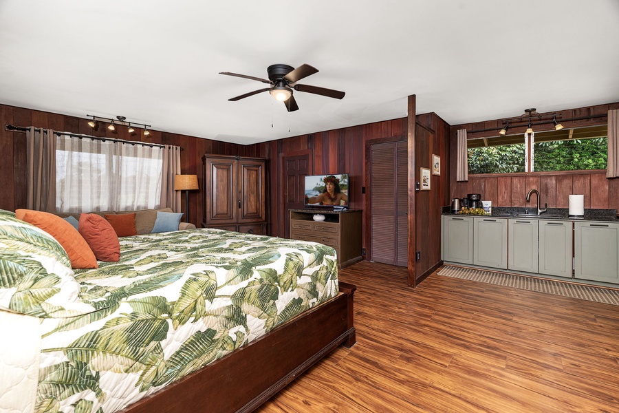 Relax in bed with tropical-print linens, enjoy the kitchenette's convenience, and cool off under the ceiling fan as natural light streams through plantation shutters.