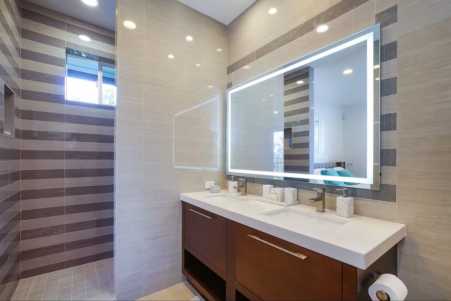 Twin sinks and a lighted vanity give the morning routine plenty of elbow room.