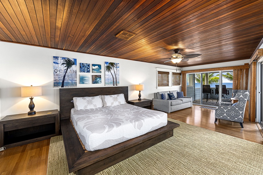 Primary bedroom styled with Restoration Hardware furnishings and warm wood ceiling.